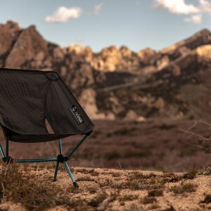 Ein Campingstuhl vor einem Berg.